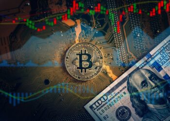 Golden bitcoin cryptocurrency on computer electronic circuit board., Bitcoin and microchip concept.